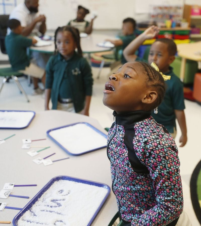 Jada Gray, 6, spells out a word during a sound stretching activity in the literacy center at Charles R. Drew Charter School in Atlanta. The activity helps students segment sounds and words. Nonsense words are used to ensure students can apply the phonics rules they’ve learned. 