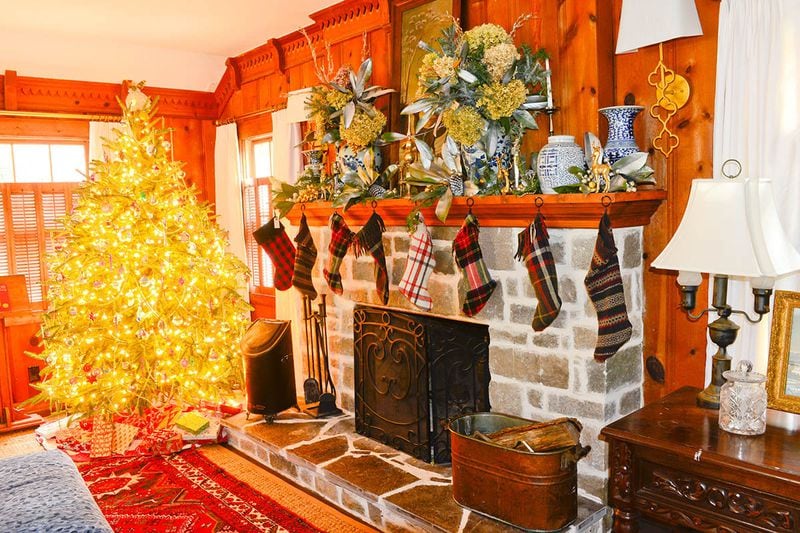 The stockings are hung by the chimney as a way for author Kathy Hogan Trocheck (aka Mary Kay Andrews) to deal with write's block. She made these stockings out of wool blankets and thrift store sweaters. On the mantel, Trocheck filled blue-and-white ceramic pieces with dried hydrangeas. The tree is one of four in the home, which is on the December 11 Avondale Estates Christmas Tour of Homes. Text by Lori Johnston and Shannon Adams/Fast Copy News Service.