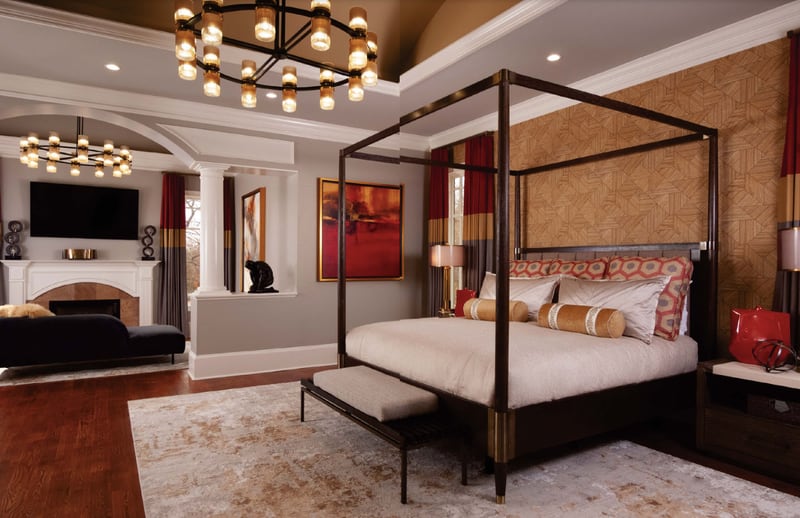 Atlanta sisters and design partners Barbara Elliot and Jennifer Ward-Woods chose a warm palette of gold, gray and red to create a modern and masculine principle bedroom.