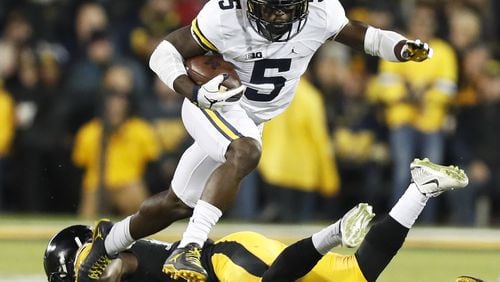 FILE - In this Nov. 12, 2016, file photo, Michigan’s Jabrill Peppers (5) breaks a tackle by Iowa defensive back Desmond King, rear, during the first half of an NCAA college football game, in Iowa City, Iowa. With safeties such as LSU’s Jamal Davis and Ohio State’s Malik Hooker available, the former Michigan star and Heisman Trophy finalist might slip out of the first round of the NFL Draft. (AP Photo/Charlie Neibergall, File)