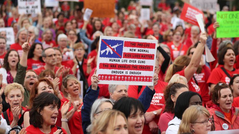 A protester holds a sign during the Moms Demand Action Advocacy Day rally at Liberty Plaza Wednesday, Feb. 21, 2018, in Atlanta, lobbying for stricter gun laws. PHOTO / JASON GETZ