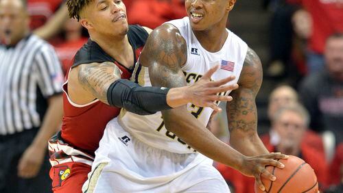 Louisville's Damion Lee (0) attempts to get the ball away from Georgia Tech's Marcus Georges-Hunt (3) during the second half of an NCAA college basketball game, Tuesday, March 1, 2016 in Louisville Ky. Louisville won 56-53. (AP Photo/Timothy D. Easley)