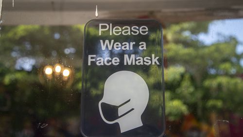 07/29/2021 —Atlanta, Georgia —  A sign asking customers to wear a mask is displayed on the exterior door of the vintage clothing store Drugstore Atlanta in Atlanta’s Little Five Points community, Thursday, July 29, 2021. (Alyssa Pointer/Atlanta Journal Constitution)