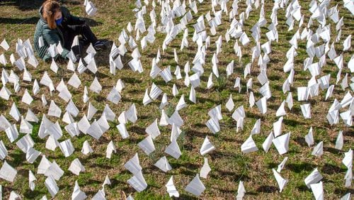 In February, volunteers planted flags on the lawn of First Christian Church of Decatur, representing the number of COVID-19 deaths in Georgia — 15,000 at the time. On Thursday, Georgia reported a total number of 25,042 confirmed deaths due to COVID-19, the first time that the state had topped 25,000. (Steve Schaefer for The Atlanta Journal-Constitution)