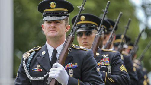 Georgia Army National Guard Honor Guard Specialist Ronnie Reddish stands at attention during the Memorial Day ceremony at the Marietta National Cemetery on Monday, May 29, 2017. JOHN SPINK/JSPINK@AJC.COM.