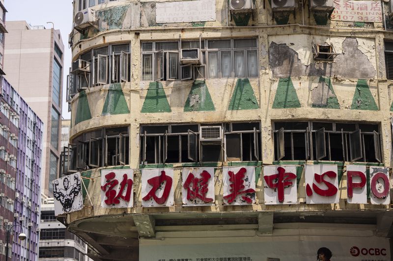 Damages are seen on a building called New Lucky House where a fire started in Hong Kong, Wednesday, April 10, 2024. (AP Photo/Louise Delmotte)