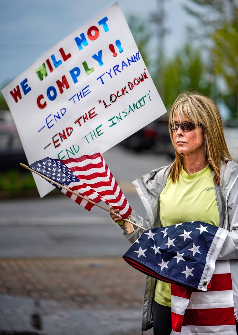 Protesters turned out on Sunday, April 19, 2020, at the Cherokee County Courthouse in Canton. The sign proclaims: We will not comply!! End the tyranny. End the "lockdown." End the insanity. (Photo: Ben Hendren/Special to the AJC)
