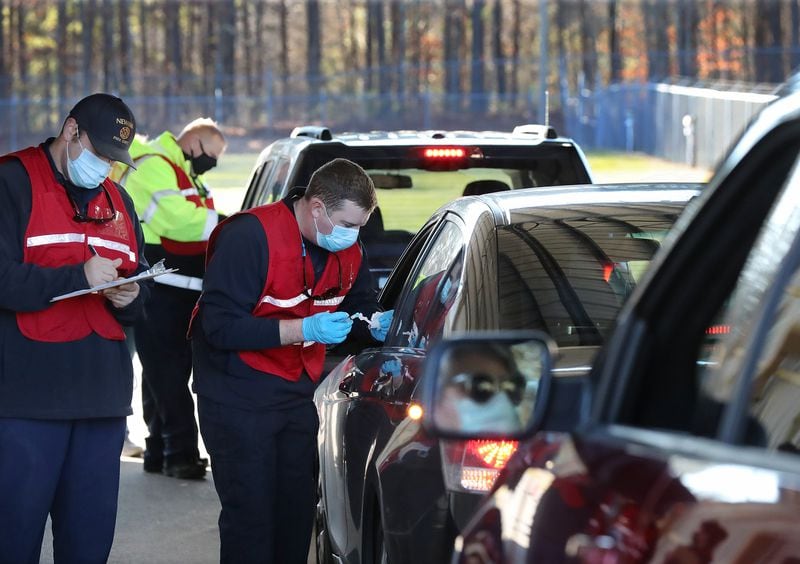 Motorists who preregistered line up for their COVID-19 vaccinations in the drive-thru vaccination site at the Coweta County Fairgrounds, where more than 900 were vaccinated on Thursday. (Curtis Compton / Curtis.Compton@ajc.com)
