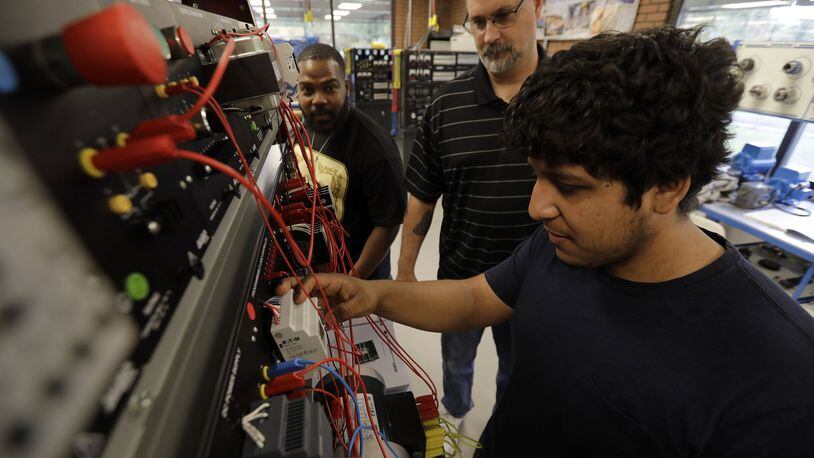 Steve Nagy, 50, center, an industrial electrical instructor, keeps any eye as students Alvin Counts, 42, left, and Edgardo Aguirre , 22, trouble shoot an electrical problem at Industrial Electrical Laboratory at InTech Center on Oct. 2, 2018 in Fontana, Calif. (Irfan Khan/Los Angeles Times/TNS)