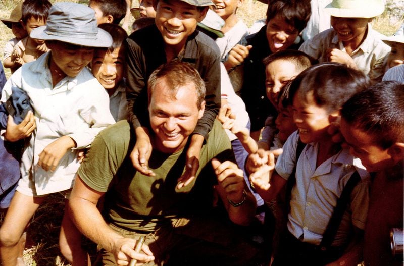 Capt. Philip Smith, of the 48th Assault Helicopter Company, is surrounded by the children of South Vietnam. CONTRIBUTED BY ATLANTA HISTORY CENTER