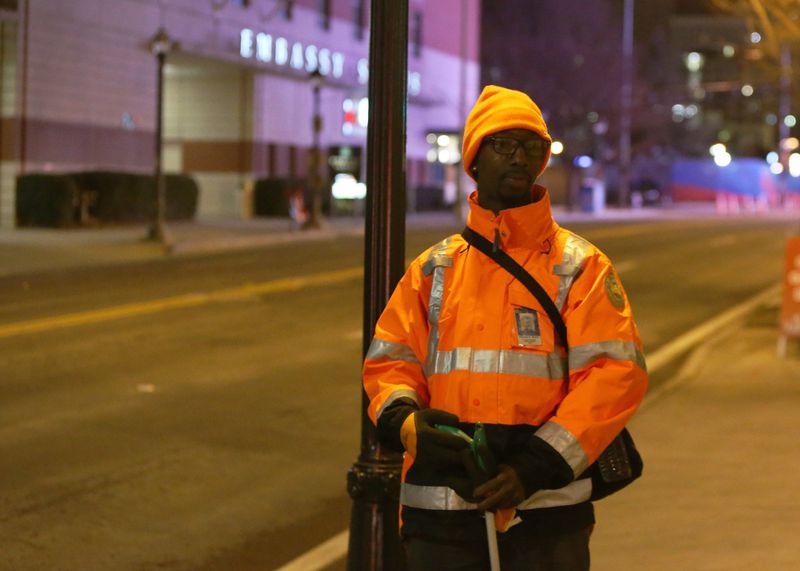 Kholoma Murray, an equipment operator for the city of Atlanta, cleans the streets of Atlanta early on Friday. The city of Atlanta has increased its efforts to keep the streets clean for the Super Bowl. EMILY HANEY/ EMILY.HANEY@AJC.COM