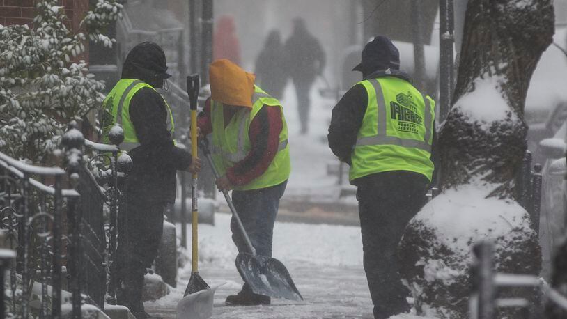 BOSTON, MA - FEBRUARY 09: A cleaning crew works to remove snow in the Beacon Hill neighborhood as a winter storm strengthens on February 9, 2017 in Boston, Massachusetts. A local meteorologist was reporting on the storm when her shot was crashed by man in costume covered in marijuana leaves. (Photo by Scott Eisen/Getty Images)