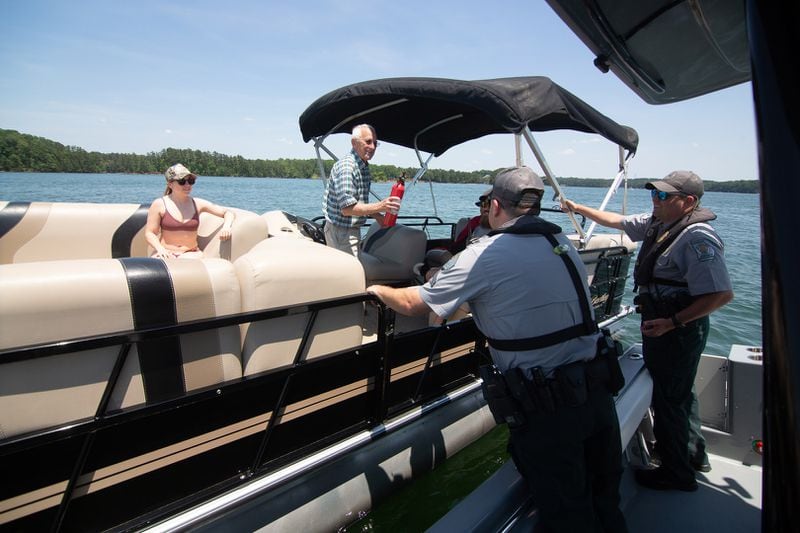 Game Warden Cpl. Dan Schay (left) and Game Warden 1st Class Kevin Goss perform a safety check on a pontoon boat on Lake Lanier on Friday, May 21, 2021. (STEVE SCHAEFER for The Atlanta Journal-Constitution)