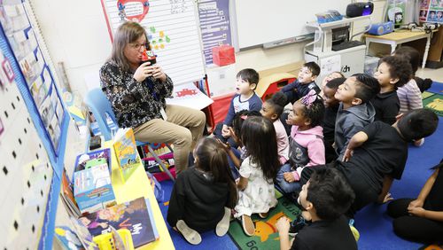 Sally Miller, City of Marietta Language and Literacy Liaison, works with pre-k students at Cobb Head Star school using phonological awareness skills (beginning sound), alphabet knowledge, and concepts of print. The Georgia Board of Education passed new guidelines Thursday concerning how English language arts is taught in schools. (Miguel Martinez / miguel.martinezjimenez@ajc.com)