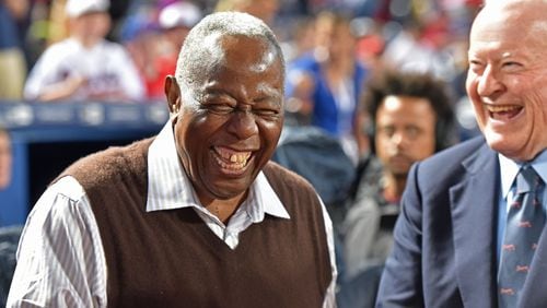Former Braves owner Bill Bartholomay (right) shares a laugh with Hank Aaron before the Braves’ home opener this year. HYOSUB SHIN / HSHIN@AJC.COM