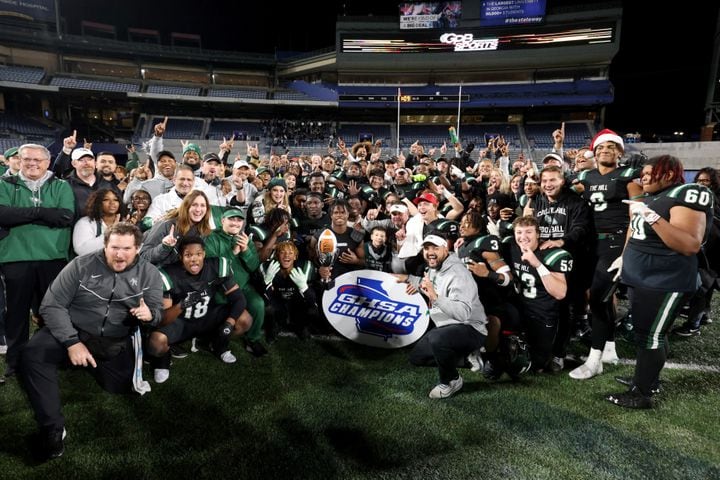 Collins Hill players and staff pose for a group photograph after their 24-8 win against Milton in the Class 7A state title football game at Georgia State Center Parc Stadium Saturday, December 11, 2021, Atlanta. JASON GETZ FOR THE ATLANTA JOURNAL-CONSTITUTION