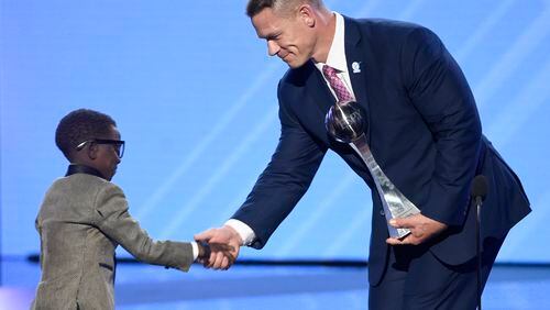 John Cena, right, presents New Orleans Saints superfan Jarrius "J.J." Robertson the Jimmy V perseverance award at the ESPYS at the Microsoft Theater on Wednesday, July 12, 2017, in Los Angeles. (Photo by Chris Pizzello/Invision/AP)