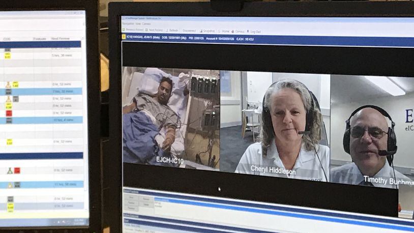 Dr. Tim Buchman, director of the Emory Critical Care Center and Cheryl Hiddleson, a registered nurse and director of the Emory eICU (electronic intensive care unit), stationed in Australia, talked to patient Jean Vargas at Emory Johns Creek Hospital in 2018. File photo