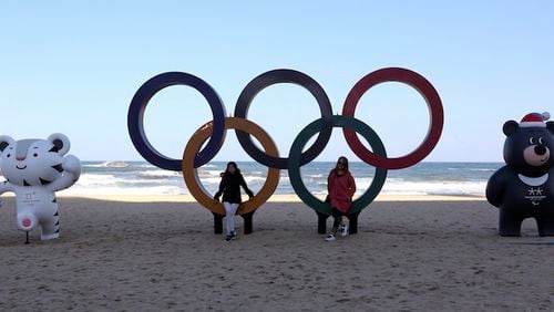 HOLD FOR USE WITH STORY SLUGGED SOUTH KOREA OLYMPIC Q&A - In this Oct. 30, 2017, file photo, the Olympic Rings, Winter Olympic Games' official mascots, white tiger Soohorang, left, for the Olympics, and black bear Bandabi for Paralympics are placed at the Gyeongpodae beach, in Gangneung, South Korea. (AP Photo/Ahn Young-joon, File)
