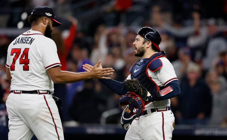 Atlanta Braves relief pitcher Kenley Jansen (74) and catcher Travis d'Arnaud (16) celebrate a 3-0 win over the Philadelphia Phillies during the ninth inning of game two of the National League Division Series at Truist Park in Atlanta on Wednesday, October 12, 2022. (Jason Getz / Jason.Getz@ajc.com)