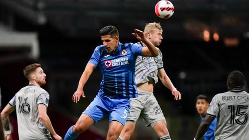 Luis Abram of Mexico's Cruz Azul, left, and Róbert Thorkelsson of Canada's CF Montreal fight for the ball during a CONCACAF Champions League quarterfinal soccer match in Mexico City, Wednesday, March 9, 2022. (AP Photo/Eduardo Verdugo)