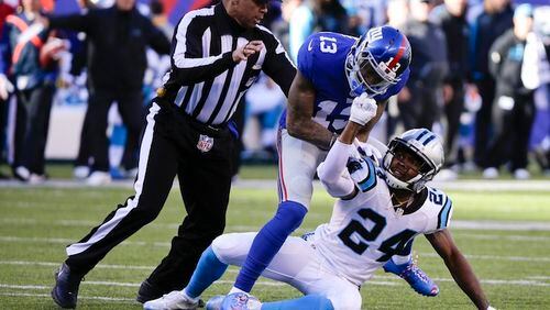 A referee, left, separates New York Giants wide receiver Odell Beckham (13) and Carolina Panthers' Josh Norman (24) during the first half of an NFL football game Sunday, Dec. 20, 2015, in East Rutherford, N.J. (AP Photo/Julie Jacobson)