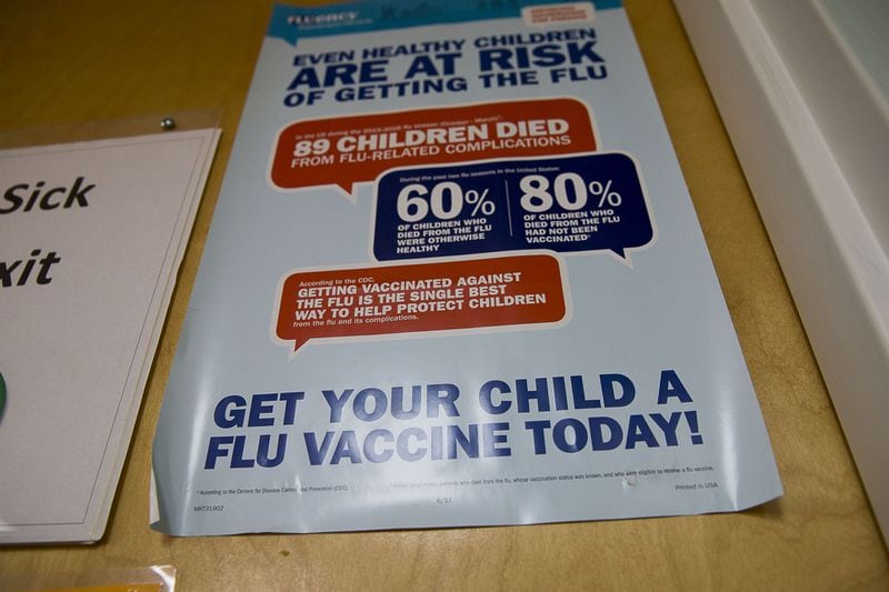 A flu vaccine poster is displayed at Conyers Pediatrics in Conyers. (Alyssa Pointer/Atlanta Journal-Constitution)