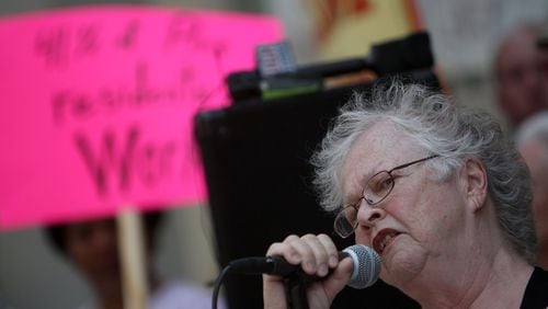 Anita Beaty rallies the crowd at the corner of Peachtree and Pine Streets during a protest about foreclosure issues at the homeless shelter in Atlanta on May 13, 2010. (Vino Wong / vwong@ajc.com)