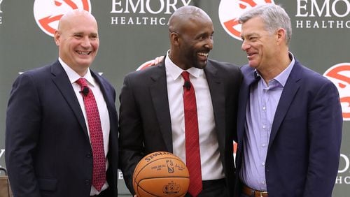 The Atlanta Hawks general manager Travis Schlenk (left) and owner Tony Ressler (right) introduce Lloyd Pierce as the 13th full-time coach in the Atlanta history of the NBA basketball franchise on Monday, May 14, 2018, in Atlanta. Pierce joins the Hawks after spending the past five seasons as an assistant coach with the 76ers. He also spent time with the Cavaliers, Warriors and Grizzlies organizations.   Curtis Compton/ccompton@ajc.com