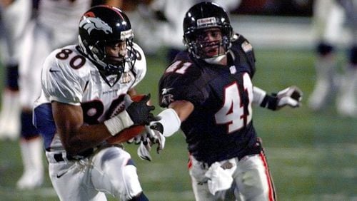 Denver Broncos wide receiver Rod Smith (80) catches a pass for a touchdown as Atlanta Falcons saftey Eugene Robinson (41) moves in during the second quarter of Super Bowl XXXIII at Pro Player Stadium in Miami, Sunday, Jan. 31, 1999. (AP Photo/Elise Amendola)