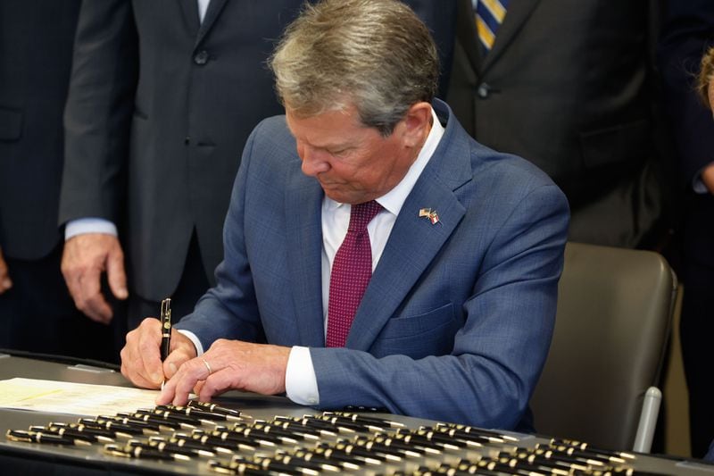 Gov. Brian Kemp is pictured signing House Bill 1105 into law.