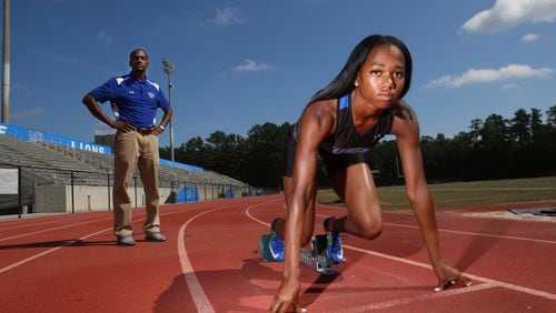 Kennedy Simon (right), a junior, and Robert Wilson (left), the head track coach, pose for a portrait at Westlake High School in Atlanta, Georgia, on May 18, 2017. Simon recently placed first in the long jump, 400m dash, and 200m dash at the 2017 GHSA Track and Field State Championships and is looking at the University of Georgia, Tennessee, and Miami as possible college destinations. (HENRY TAYLOR / HENRY.TAYLOR@AJC.COM)
