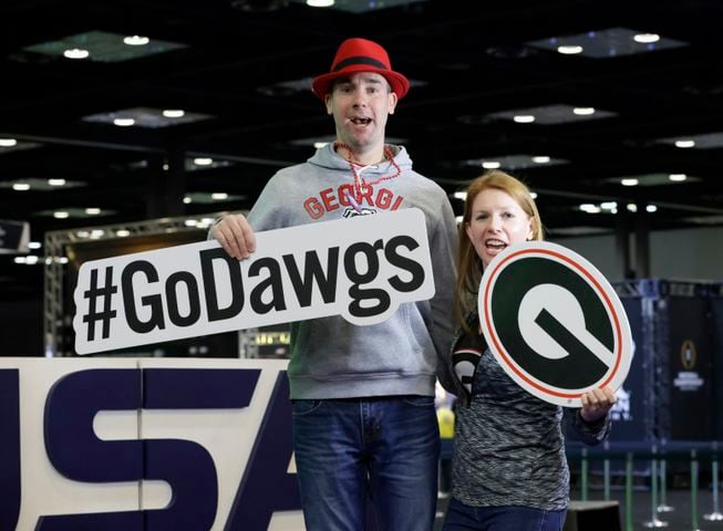 PJ and Mikaela Whirity, from Chicago root for Georgia in the 3d photo booth at Fan Central.  PJ said he has been a Georgia fan since Uga V snapped at a player in the 1996 Auburn game and has fond memories of watching games with his dad.  Fan Central is in the Indiana Convention Center at the 2022 College Football Playoff National Championship  between the Georgia Bulldogs and the Alabama Crimson Tide at Lucas Oil Stadium in Indianapolis on Saturday, January 8, 2022.   Bob Andres / robert.andres@ajc.com