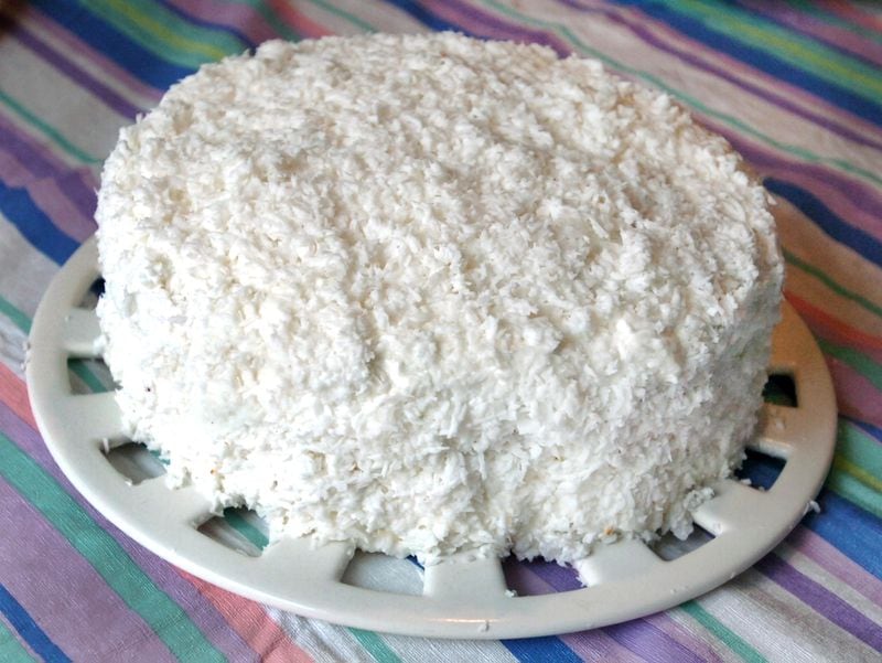070313 - CONYERS, GA -- The famous Rich's coconut cake, made by Carl Dendy , wih help from local baker Angie Mosier , in Dendy's kitchen at his home in Conyers.  Story about one of the most requested recipes in Atlanta, the coconut cake made at the Rich's bakery that closed more than 20 years ago.  (CHARLOTTE B. TEAGLE / AJC Staff).