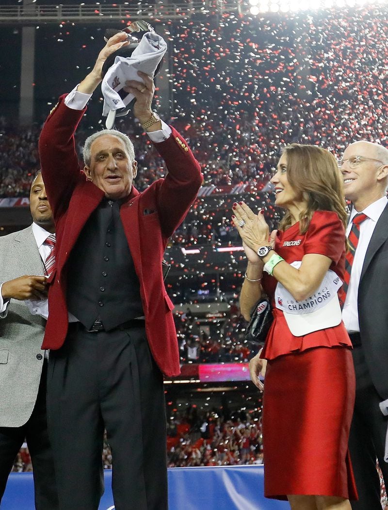  Atlanta Falcons owner Arthur Blank holds the George Halas Trophy after defeating the Green Bay Packers with hi wife, Angela Macuga, in the NFC Championship Game at the Georgia Dome on January 22, 2017 in Atlanta. The Falcons defeated the Packers 44-21. ( Kevin C. Cox/Getty Images)