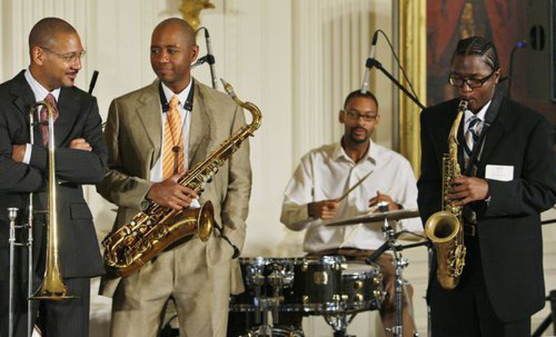 In a photo from 2009, trombonist Delfeayo Marsalis, saxophonist Branford Marsalis, and drummer Jason Marsalis listen as student Phillip Syle of New Orleans plays a solo during a jazz workshop in the East Room of the White House. CONTRIBUTED:  CHARLES DHARAPAK/AP