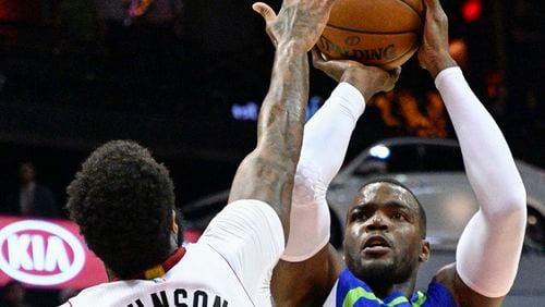 Atlanta Hawks forward Paul Millsap shoots as Miami Heat forward James Johnson defends during the first half of an NBA basketball game, Friday, Feb. 24, 2017, in Atlanta. (AP Photo/John Amis)