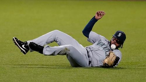 Seattle Mariners right fielder Phillip Ervin slides to reach for a ball hit by San Francisco Giants' Donovan Solano during the fourth inning Wednesday, Sept. 16, 2020, in San Francisco. (Jeff Chiu/AP)