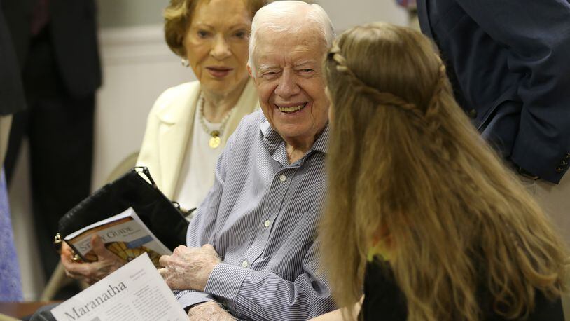 August 16, 2015 Plains: Former President Jimmy Carter talks with neighbor Stephanie Wynn before the start of bible study at Maranatha Baptist Church in Plains on Sunday morning August 16, 2015. Sunday at church was emotional because it was the first time many people had seen Carter since his announcement that he has cancer. Ben Gray / bgray@ajc.com