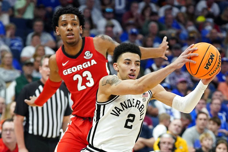 Vanderbilt guard Scotty Pippen Jr. (2) drives past Georgia guard Braelen Bridges (23) during the first half of an NCAA college basketball game in the Southeastern Conference men's tournament Wednesday, March 9, 2022, in Tampa, Fla. (AP Photo/Chris O'Meara)