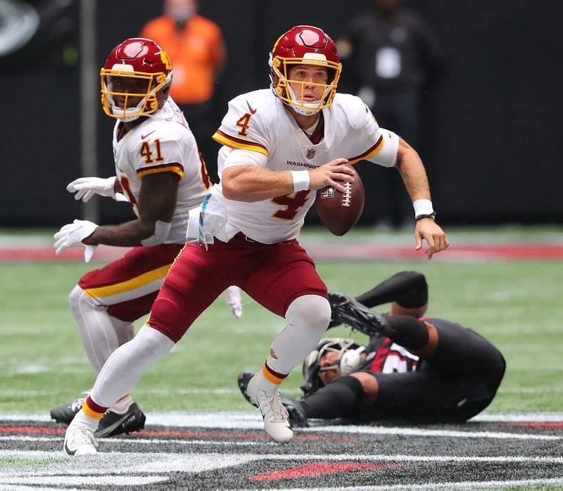 Washington Football Team quarterback Taylor Heinicke runs for a first down against the Falcons during the first half Sunday, Oct. 3, 2021, at Mercedes-Benz Stadium in Atlanta. (Curtis Compton / Curtis.Compton@ajc.com)