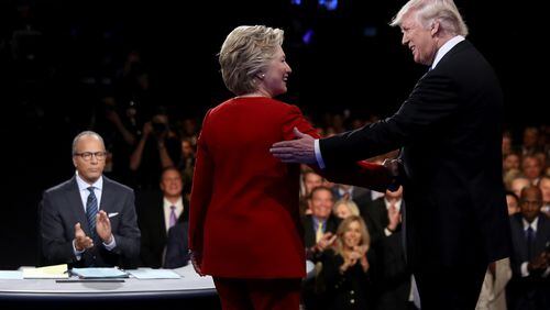 Democratic presidential nominee Hillary Clinton shakes hands with Republican presidential nominee Donald Trump as Moderator Lester Holt looks on during the Presidential Debate at Hofstra University on September 26, 2016 in Hempstead, New York. (Photo by Joe Raedle/Getty Images) *** BESTPIX ***