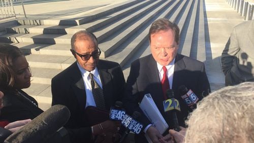Elvin “E.R.” Mitchell Jr., left, stands with his attorney before a crowd of reporters outside the federal courthouse in downtown Atlanta on Wednesday, Jan. 25, 2017. Mitchell pleaded guilty to conspiring to pay more than $1 million in bribes as part of a scheme to win city of Atlanta contracts. Dave Huddleston/Channel 2 Action News