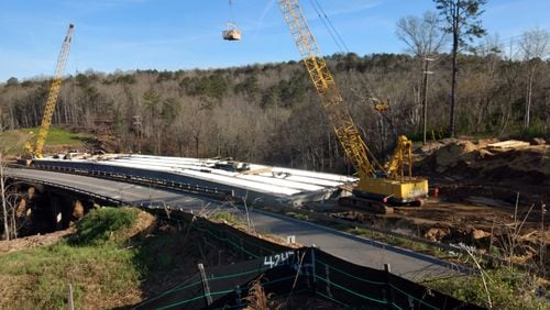 With the current Arnold Mill Bridge in the foreground alongside, the new bridge is taking shape. It is wider than the current bridge. The completed bridge will provide two 12 foot lanes with a 10 foot shoulder, according to Georgia Department of Transportation.