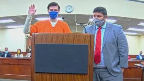 Luke Austin Lane, 23, raises his hand to be sworn in Floyd County District Court Friday, Nov. 19, 2021. Lane, described as a ringleader of a local cell of the white supremacist group The Base, was sentenced to 13 years in prison for plotting to kill a Bartow County couple.