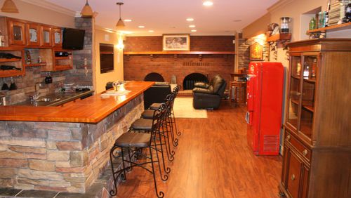 A lower level bar and game table creates a warm and inviting space. (Handout/TNS)