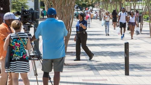 A Clark Atlanta University security office tells news crews they have to move to the public sidewalk & off campus property near where shooting reportedly broke out during a party on the steps of the Atlanta University Center early Wednesday morning injuring several students on the first day of classes in Atlanta, GA on August 21st, 2019. (Photo by Phil Skinner / For The Atlanta Journal-Constitution).