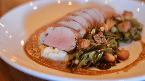 The grilled pork tenderloin, collard greens, toasted cornbread, Anson Mills grits and apple mustard is one of the entree offerings at Kitchen Six. (photo: Henri Hollis for the AJC)