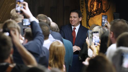 Florida Gov. Ron DeSantis greets supporters as he arrives at an event spotlighting his newly released book, "The Courage To Be Free: Florida's Blueprint For America's Revival," at the Adventures Outdoors on Thursday, March 30,  in Smyrna. Miguel Martinez / miguel.martinezjimenez@ajc.com