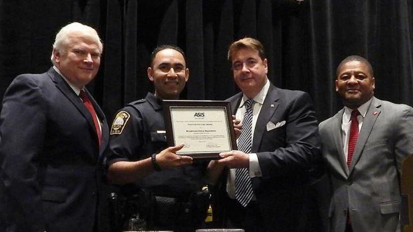 Brookhaven Police Chief Gary Yandura (far left) and Officer Carlos Nino (center left) receiving the Positive Policing Award from John Garrigan (center right) and Jeremiah Frazier (far right) of the ASIS Greater Atlanta Chapter.